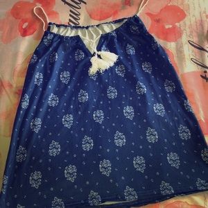 a blue navy shirt with decor all over the shirt